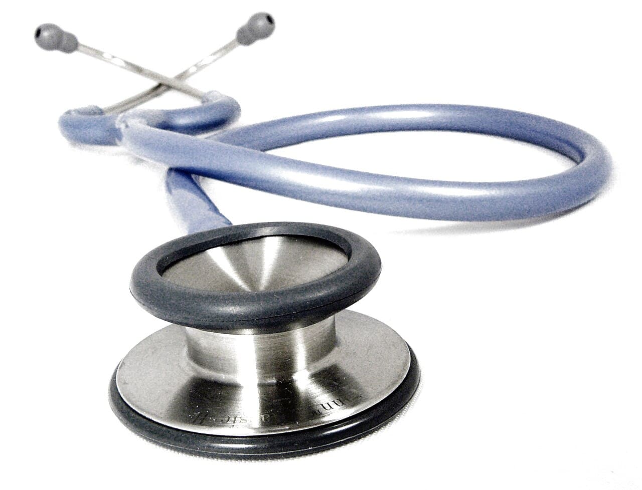 A doctor's stethoscope coiled on a desk