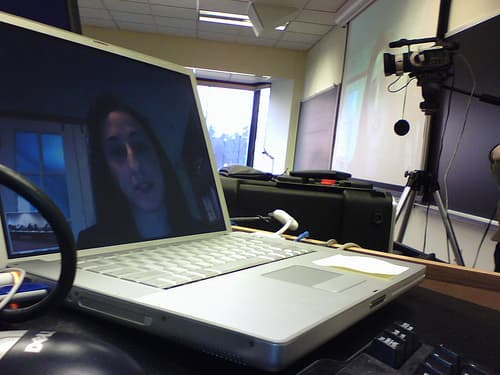 People taking part in a video conference on a laptop